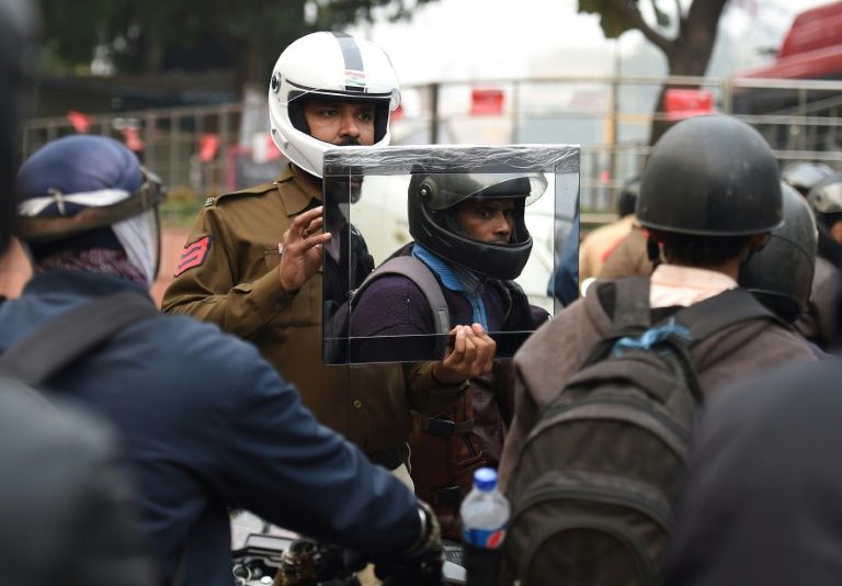 Delhi Policeman Holds Up Mirror Photo Credit Express Tribune