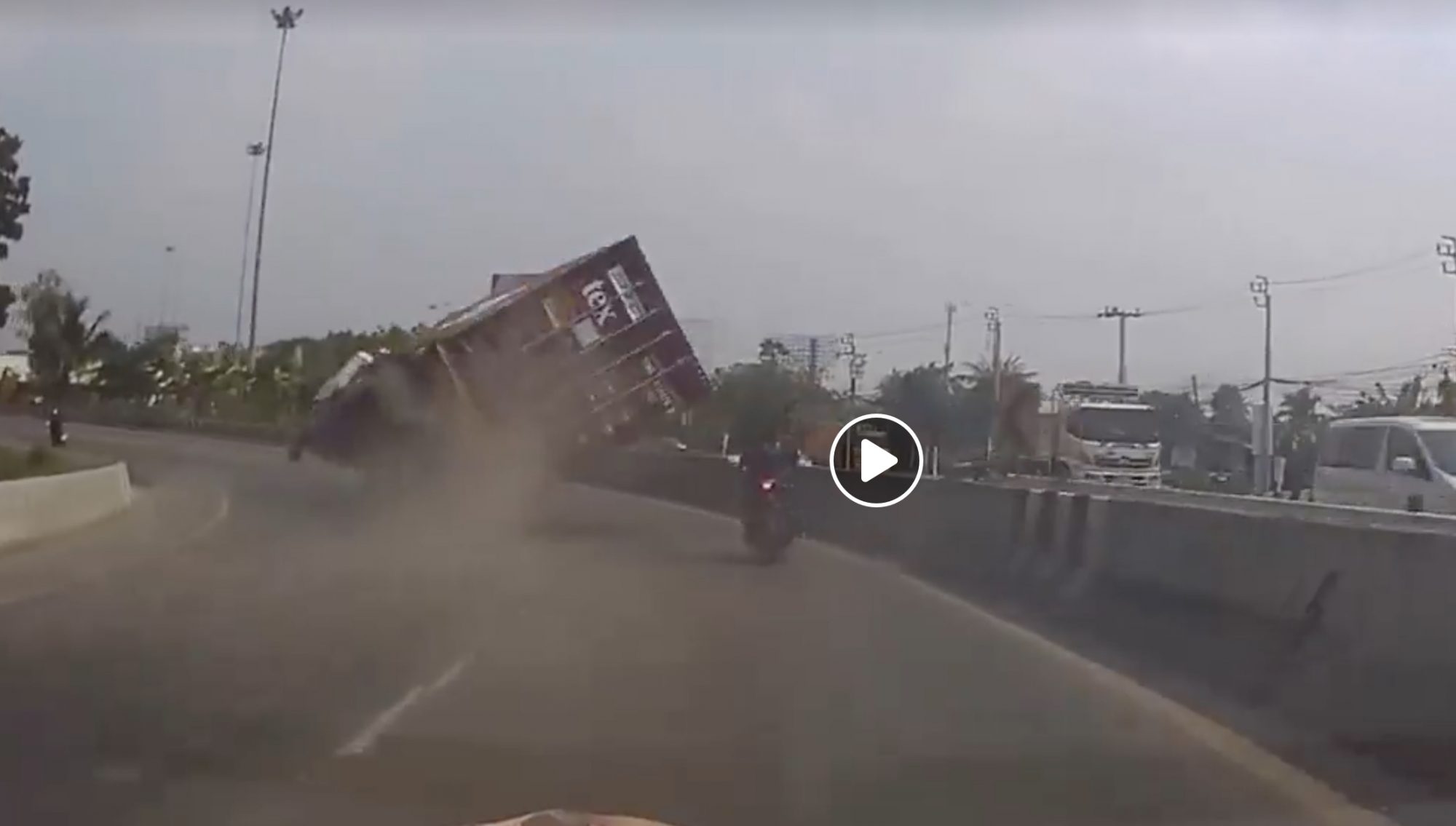 Motorcyclist Misses Truck Tipping Over